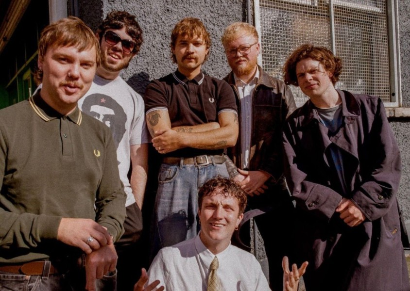 Madra Salach stood in front of a grey buildingx